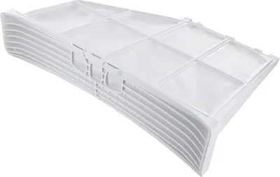 A white lint filter for a dryer, stacked on top of other filters.