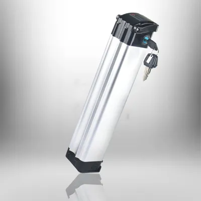 A silver e-bike battery pack with a black top and a key inserted into a lock, set against a gradient background.