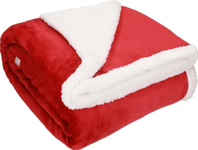 A folded red blanket with a white sherpa lining.