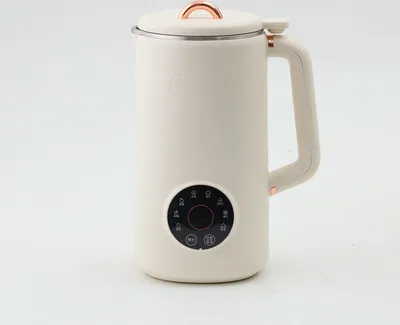 A cream-colored electric kettle with rose gold accents, set against a white background.