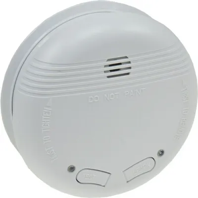A white smoke detector is shown from a slightly elevated angle against a white background.