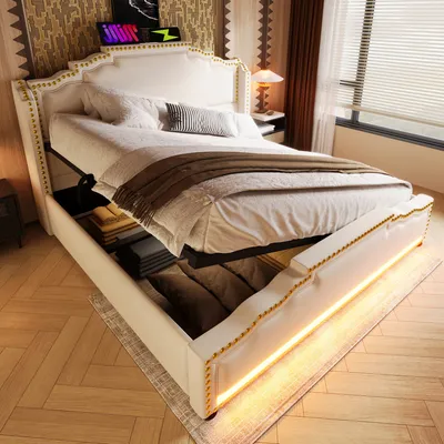 A bedroom scene featuring a white upholstered bed with storage underneath and LED lighting.