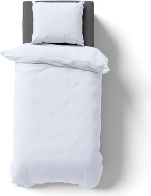 A top-down view of a white duvet and pillow on a gray headboard, set against a white background with a shadow.