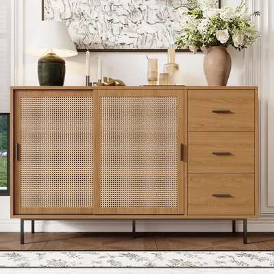 A wooden sideboard with cane doors and three drawers, displayed in a well-lit room with decorative items on top.