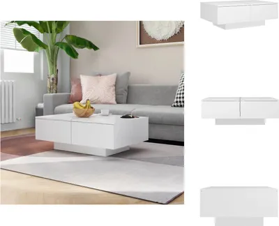 A white coffee table is placed in a living room setting in front of a sofa.