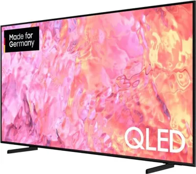 A Samsung QLED TV displaying a colorful abstract image, with a stand and a corner logo.