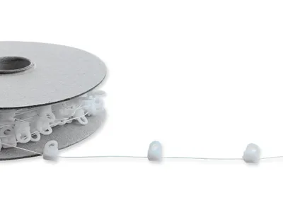 A roll of white curtain glider cord with individual gliders attached, shown on a white background.