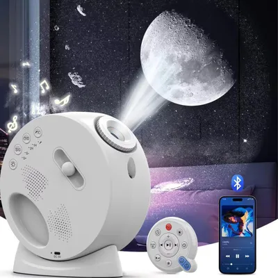 A white star projector with a moon projection, a remote control, and a smartphone displaying music are shown in a dimly lit room.