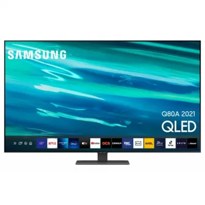 A Samsung QLED smart TV is displayed on a stand against a white background. The TV screen shows a vibrant abstract image with blue and green tones, and a row of app icons is visible at the bottom.
