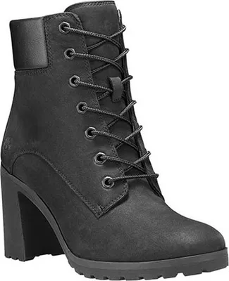 A black Timberland boot with laces and a high heel is shown against a white background.