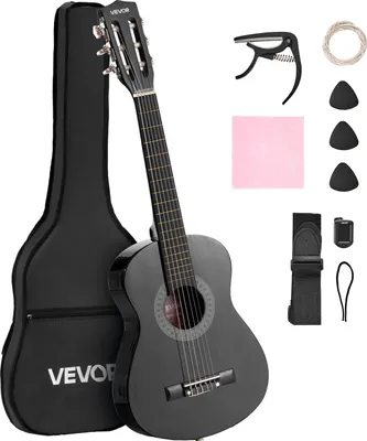 A black VEVOR acoustic guitar and its accessories are displayed against a white background. The guitar is leaning against its black gig bag. Accessories include a capo, extra strings, picks, a cleaning cloth, and a strap with a tuner.