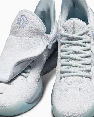 A close-up studio shot of a pair of white Converse All Star Bb Trilliant Cx Ox sneakers.