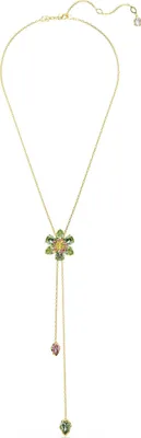 A gold necklace with a flower pendant and dangling charms.