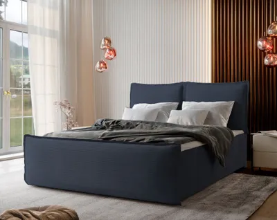 A bedroom scene featuring a blue upholstered bed with white pillows and a gray throw blanket.