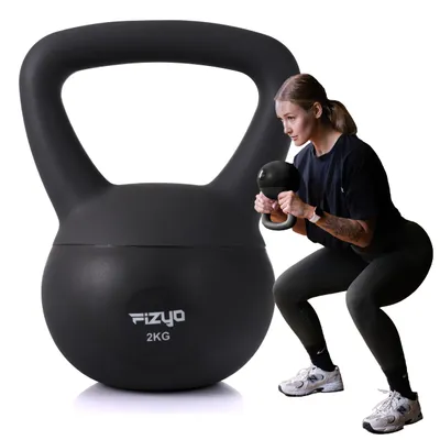 A woman is performing a squat exercise with a kettlebell, with a large kettlebell in the foreground.