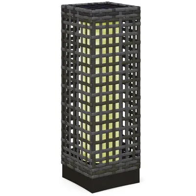 A rectangular solar lamp with a woven rattan exterior and a yellow light inside, set against a white background.