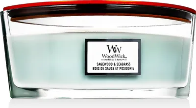 A close-up studio shot of a WoodWick candle in a glass jar with a red lid.