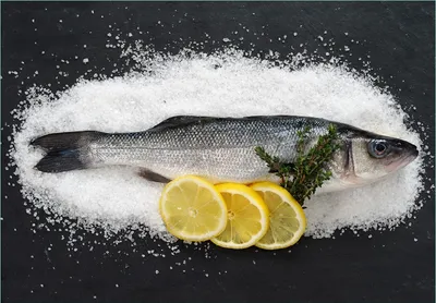 Produktbild von Wallario Fototapete Vliestapete, seidenmatte Oberfläche, einfache Verarbeitung, Größe 200 x 140 cm, Motiv Fischmenü - Frischer Fisch auf Salz mit Zitronen