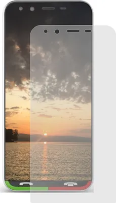A screen protector is placed over a smartphone displaying a sunset.
