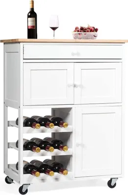 A white kitchen cart with a wooden top, a drawer, two cabinet doors, and a wine rack is shown against a white background. A bottle of wine, a wine glass, and a container of cherries are placed on top of the cart.