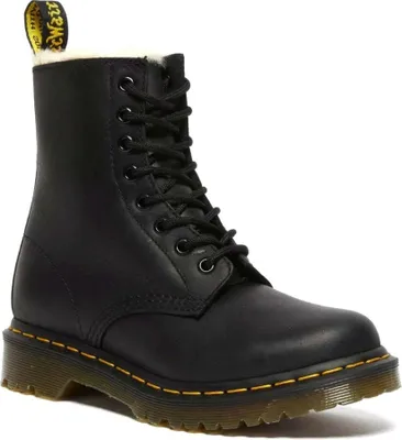 A black Dr. Martens boot with white fur lining.