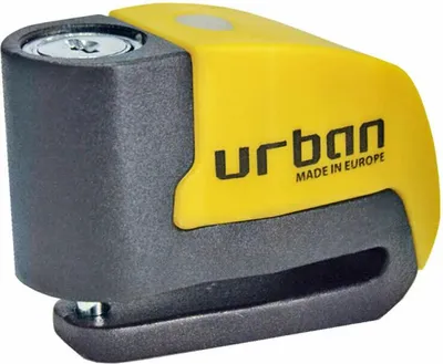 A close-up studio shot of a yellow and gray disc lock with an alarm.
