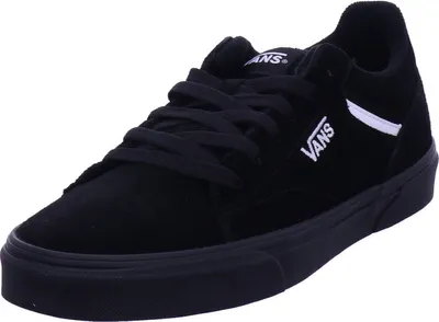 A black Vans shoe is shown from a diagonal angle against a white background.