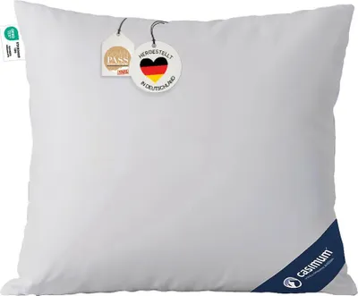 A white pillow with tags attached.