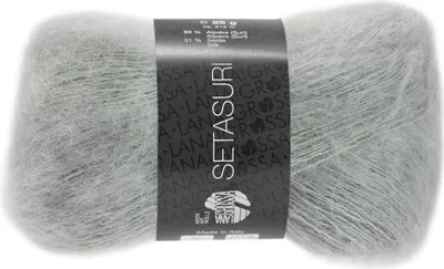 A ball of light gray yarn with a label wrapped around it.