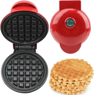 A red mini waffle maker is shown open, revealing its non-stick plates. A stack of golden-brown mini waffles sits to the right of the waffle maker.