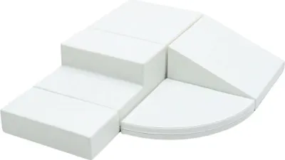 A set of white foam blocks arranged in a playful, modular structure, resembling steps and a ramp.