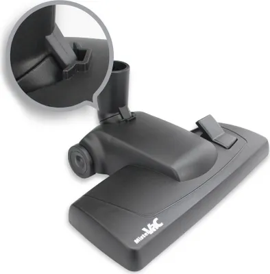 A close-up, angled shot of a black vacuum cleaner attachment on a white background. An inset magnifying circle highlights a latch mechanism on the attachment.