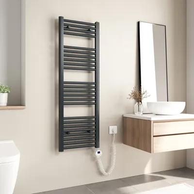 A modern bathroom with a dark grey electric towel warmer mounted on the wall next to a toilet and a vanity with a sink and mirror.