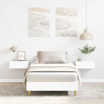 A minimalist bedroom scene featuring a white bed frame.