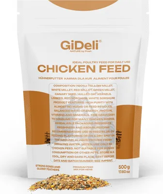 A bag of chicken feed with some feed spilled in front of it.