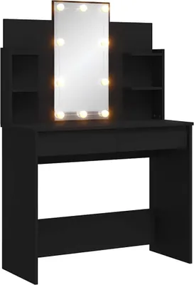 A black vanity table with a mirror illuminated by LED lights.