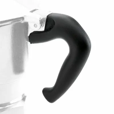 Close-up of a black handle attached to a silver coffee pot.