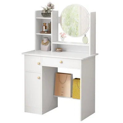 A white vanity table with a mirror, shelves, and drawers, decorated with various items.