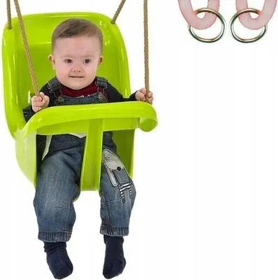 A baby sitting in a green swing.