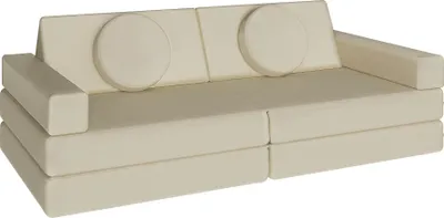 A cream-colored modular sofa with two round cushions.