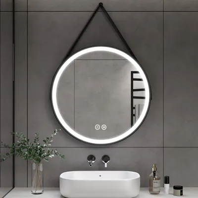 A modern bathroom vanity area with a round LED mirror above a sink.