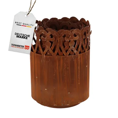 A rusty metal garden border with a decorative top edge, attached to a white tag.
