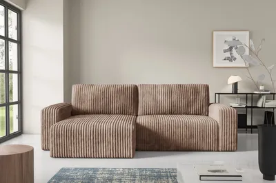 A modern living room with a cord sofa, a coffee table, and a large window.