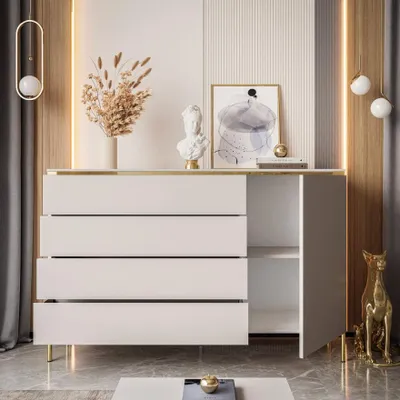 A modern white dresser with gold accents, decorated with vases and sculptures, in a well-lit room.