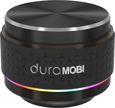 A product shot of a small, cylindrical speaker with a textured black body and a brushed metal top.