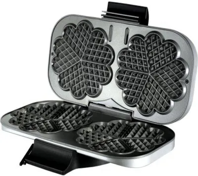An open waffle maker with heart-shaped waffle plates.