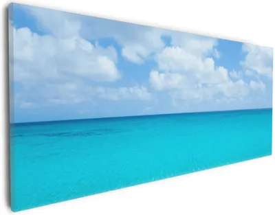 Produktbild von Wallario Premium Leinwandbild Sandstrand und blaues Meer in Größe 30 x 75 cm