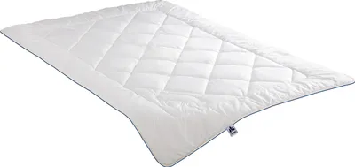 A white quilted duvet is shown from a diagonal angle against a white background.
