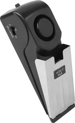 A black and silver door stopper alarm is shown from a diagonal angle against a white background.