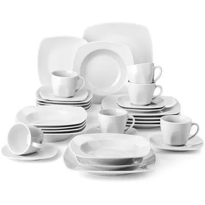 A collection of white ceramic dinnerware and cups arranged on a white background.